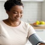 Person measuring blood pressure at home.